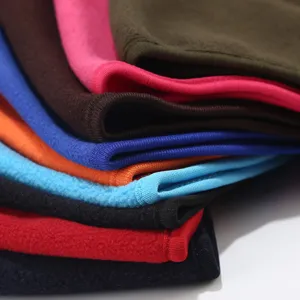 Close-up view showing colorful fleece fabric stacks, soft texture and warm winter material details.