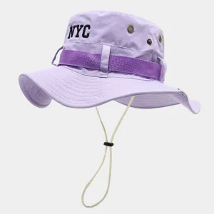 Close-up view of the light purple bucket hat featuring a chin cord and NYC embroidery.