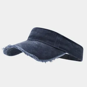 Detailed close-up of dark blue washed denim sun visor featuring frayed distressed brim.
