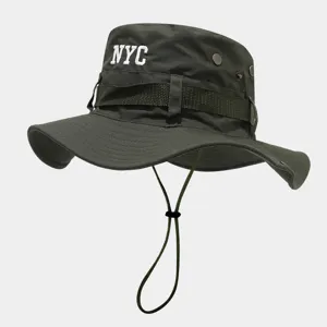 Detailed close-up view of the dark green bucket hat featuring NYC embroidery and adjustable chin strap.