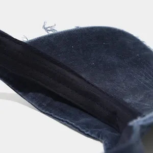 Dark blue washed distressed sun visor detail, vintage empty top cap with frayed edges.