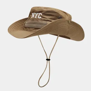 Khaki outdoor bucket hat with adjustable chin strap and white NYC letter embroidery.