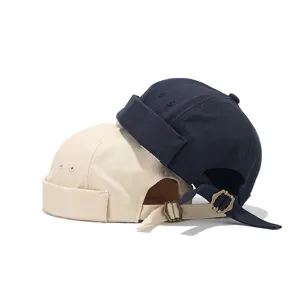 Close-up detail of canvas docker caps with adjustable metal buckle straps in dual colors.