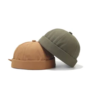 Close-up detail view of stylish canvas miki hats in khaki and army green, brimless design.
