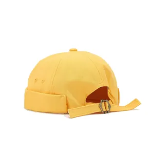 Yellow brimless miki hat dockermap detail view showing adjustable strap and metal buckle.