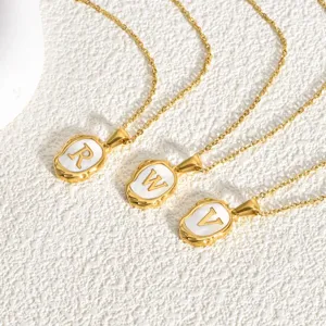 Detail view of gold stainless steel necklace with mother of pearl letter pendant R W V.
