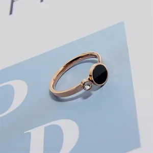 Minimalist rose gold titanium steel ring featuring a black disc and sparkling crystal detail.