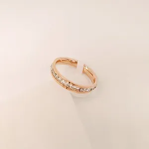 Detailed closeup of a minimalist rose gold crystal ring, sleek elegant fashion finger jewelry.