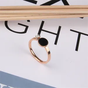 Detailed view of the rose gold titanium steel ring with a black disc and sparkling crystal.