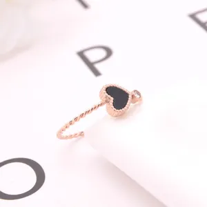 Exquisite rose gold titanium steel heart ring featuring black mother of pearl and crystal.
