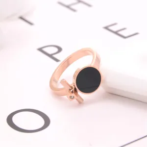 Close-up detail shot of a stylish rose gold ring with a modern black round inlay.