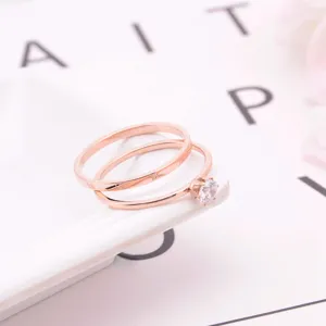 Detailed close-up shot of a chic rose gold two-piece ring set featuring a sparkling zircon.