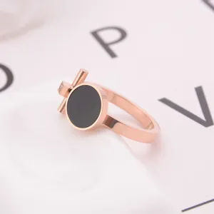 Exquisite rose gold titanium steel ring featuring black round insert and sparkling crystal detail.