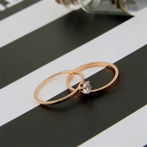 Elegant rose gold titanium steel double ring set featuring sparkling zirconia crystal detail.