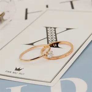 Elegant double-ring set featuring a sparkling CZ diamond and roman numeral band for women.