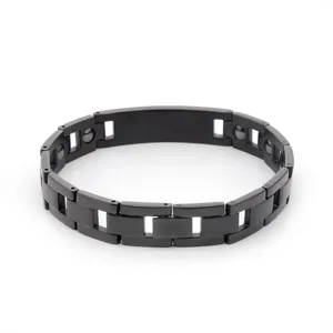 Close-up detail of black stainless steel magnetic link bracelet, minimalist design for men.