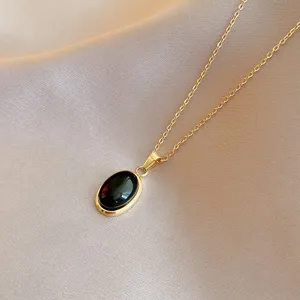 Elegant gold-tone chain necklace featuring a chic black oval gemstone pendant for daily wear.