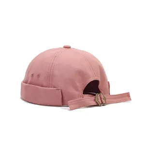 Detailed view of the back metal adjustable strap and pink canvas texture on the docker cap.