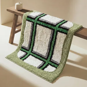 Thick absorbent bath mat with modern green geometric grid pattern, soft plush floor rug.