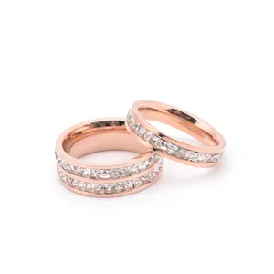 Close-up detail of stainless steel rose gold crystal rings, showcasing glittering stones.