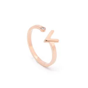 Detail view of a rose gold open ring featuring a chic V-shaped charm and crystal accent.