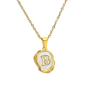 Detail view of the gold stainless steel necklace pendant featuring letter B on mother-of-pearl.