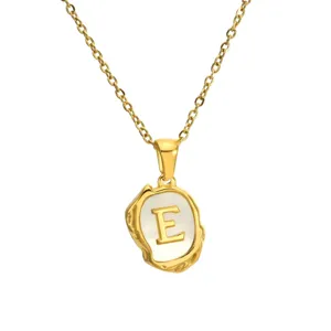 Detailed close-up of gold stainless steel letter E pendant necklace featuring mother of pearl.