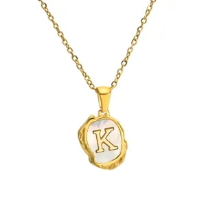 Detailed close-up view of the elegant gold necklace featuring an irregular shell letter K pendant.