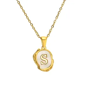 Gold stainless steel alphabet necklace with mother of pearl inlay letter S pendant.
