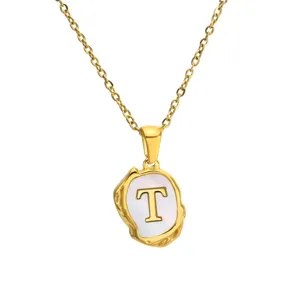 Gold stainless steel initial letter T necklace with mother of pearl pendant detail.