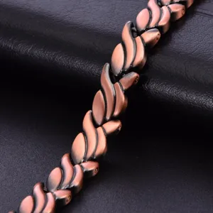 Pure copper magnetic bracelet detail shot showcasing antique leaf link texture and metallic finish.