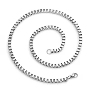 Stainless steel box chain necklace detail showing the compact square links and sturdy lobster clasp.