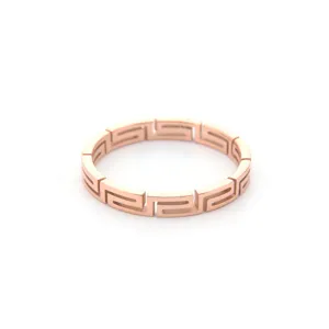 Close-up detail shot of the rose gold titanium steel ring with geometric Greek key pattern.