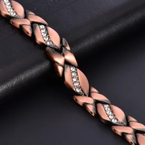 Close-up of the copper magnetic bracelet with polished leaf links and sparkling crystal stones.