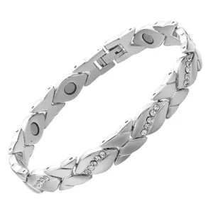 Close-up detail of silver-tone magnetic health bracelet links with sparkling rhinestones.