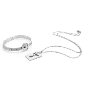 Stainless steel couple jewelry set including key lock bangle bracelet and pendant necklace.