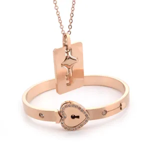 Rose gold stainless steel lock bracelet and key pendant necklace set for couples.
