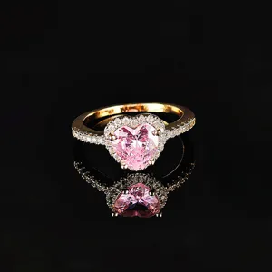 Close-up detail of the dazzling pink heart-shaped crystal ring with sparkling pavé stones.