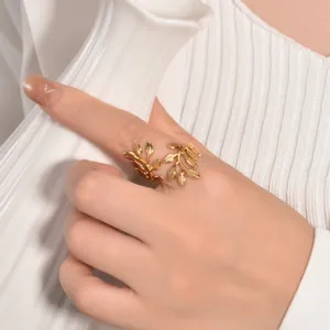 Close-up of gold stainless steel leaf open ring worn on hand, detailed accessory view.