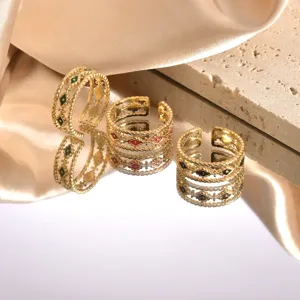 Close-up of twisted enamel open rings, 18k gold plated stainless steel fashion jewelry detail.