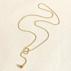 Goldene lange Schlangenkette Detailaufnahme mit Anhänger und glänzender Metallstruktur.