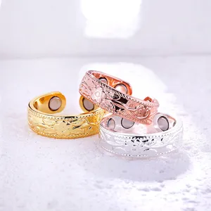 Close-up details of magnetic open rings with floral carved patterns and double magnets inside.