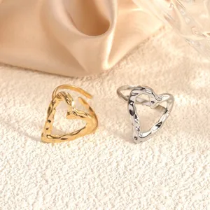Detail shot of hammered texture heart open rings in gold and silver, showcasing sleek design.
