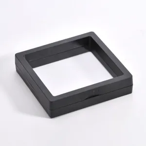Black floating frame jewelry box detail view, transparent plastic storage case for rings and earrings.