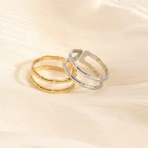 Detailed close-up of open titanium steel bamboo rings in gold and silver, elegant and stylish.