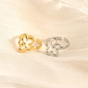 Close-up detail of adjustable stainless steel flower rings in dual gold and silver colors.