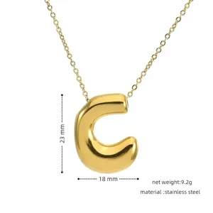 Gold puffed letter C pendant necklace detail view, showcasing the polished stainless steel surface.