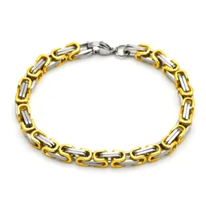 Closeup view of two-tone stainless steel Byzantine chain bracelet with lobster clasp.