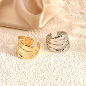 Detailed close-up of multi-strand irregular stainless steel rings in gold and silver finishes.