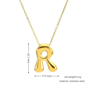 Detail shot of golden stainless steel puffy letter pendant necklace, minimalist design.